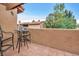 Outdoor patio area, with tile flooring, featuring a metal table and chairs and privacy wall at 5640 E Bell Rd # 1099, Scottsdale, AZ 85254