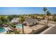 Aerial view showcases a pool, patio, and gravel backyard, enclosed by a wooden fence at 7709 W Hearn Rd, Peoria, AZ 85381