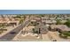 Aerial view shows the manicured front yard, two-car garage, desert landscaping, and surrounding neighborhood at 7709 W Hearn Rd, Peoria, AZ 85381