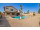 A refreshing pool enhances the appealing backyard with desert landscaping and neutral color tones at 7709 W Hearn Rd, Peoria, AZ 85381