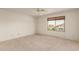 This bedroom features a ceiling fan and a window that fills the space with natural light at 7709 W Hearn Rd, Peoria, AZ 85381