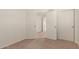 Bedroom with plush carpeting, a closet, and a view of the stairs and upper level at 7709 W Hearn Rd, Peoria, AZ 85381
