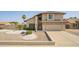 Exterior elevation of a two-story home with desert landscaping and a spacious two-car garage at 7709 W Hearn Rd, Peoria, AZ 85381