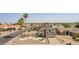 A charming two-story home with a well-manicured yard and desert landscaping with rocks and palm trees at 7709 W Hearn Rd, Peoria, AZ 85381