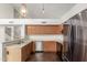Bright kitchen showcasing modern appliances, a breakfast bar, and stone floors at 7709 W Hearn Rd, Peoria, AZ 85381