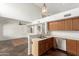 Bright kitchen featuring wood cabinets, stainless steel appliances, pendant lights, and stone floors at 7709 W Hearn Rd, Peoria, AZ 85381