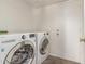 Laundry room with a washer and dryer and tile floors and access to the exterior at 7709 W Hearn Rd, Peoria, AZ 85381