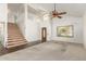 Spacious living room with a high ceiling, a ceiling fan, and a staircase at 7709 W Hearn Rd, Peoria, AZ 85381
