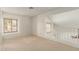 Carpeted loft area with bright windows and railing overlooking other rooms at 7709 W Hearn Rd, Peoria, AZ 85381