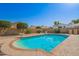 A beautiful pool with rock detail enhances this desert landscape backyard with block walls at 7709 W Hearn Rd, Peoria, AZ 85381
