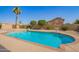 Inviting swimming pool surrounded by lush greenery and desert landscaping at 7709 W Hearn Rd, Peoria, AZ 85381