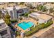 A beautiful pool and spa area in a community, surrounded by lounge chairs and lush landscaping at 7710 E Gainey Ranch E Rd # 115, Scottsdale, AZ 85258