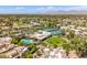 Expansive aerial view of the community showcasing lush landscaping, pool, tennis courts, and golf course at 7710 E Gainey Ranch E Rd # 115, Scottsdale, AZ 85258