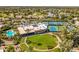 Scenic aerial view of community center, pool, and manicured green spaces in a well-maintained neighborhood at 7710 E Gainey Ranch E Rd # 115, Scottsdale, AZ 85258