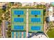 Aerial shot showcasing tennis courts surrounded by lush greenery, part of a well-maintained community recreational area at 7710 E Gainey Ranch E Rd # 115, Scottsdale, AZ 85258