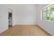 Bright bedroom with wood-look floors, white walls, and modern window at 7710 E Gainey Ranch E Rd # 115, Scottsdale, AZ 85258