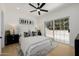 Bright bedroom features an area rug, neutral colors, and sliding door to the patio at 7710 E Gainey Ranch E Rd # 115, Scottsdale, AZ 85258
