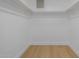 Walk-in closet with minimalist interior and wood-look flooring at 7710 E Gainey Ranch E Rd # 115, Scottsdale, AZ 85258