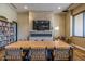 Modern conference room with a large table, fireplace, and TV, perfect for meetings and gatherings at 7710 E Gainey Ranch E Rd # 115, Scottsdale, AZ 85258