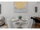 Dining area features a round table set for four with plush white chairs at 7710 E Gainey Ranch E Rd # 115, Scottsdale, AZ 85258