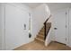 Bright foyer with sleek wood floors, modern staircase, and ample natural light at 7710 E Gainey Ranch E Rd # 115, Scottsdale, AZ 85258