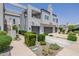 Modern townhome complex with private garages, lush landscaping, and architectural details at 7710 E Gainey Ranch E Rd # 115, Scottsdale, AZ 85258