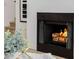 Close up of a cozy fireplace with a modern grate and decorative mantel at 7710 E Gainey Ranch E Rd # 115, Scottsdale, AZ 85258