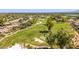 Overhead image of a green golf course with sand traps and trees in a sunny neighborhood with beautiful single-Gathering homes at 7710 E Gainey Ranch E Rd # 115, Scottsdale, AZ 85258