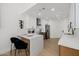 Updated kitchen with stainless steel appliances, quartz countertops, and modern light fixtures at 7710 E Gainey Ranch E Rd # 115, Scottsdale, AZ 85258