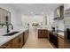 Spacious open kitchen boasts wood cabinets and stainless appliances with an open view to the living room at 7710 E Gainey Ranch E Rd # 115, Scottsdale, AZ 85258