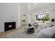Bright living room with a fireplace, vaulted ceilings, and inviting decor at 7710 E Gainey Ranch E Rd # 115, Scottsdale, AZ 85258