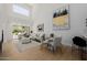 Bright living room features light wood floors, modern decor, and a glass slider to an outdoor patio at 7710 E Gainey Ranch E Rd # 115, Scottsdale, AZ 85258