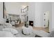 Open-concept living room with a fireplace, adjacent kitchen, and high ceilings at 7710 E Gainey Ranch E Rd # 115, Scottsdale, AZ 85258
