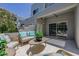 Stylish patio with modern seating arrangement and views of the contemporary building exterior and foliage at 7710 E Gainey Ranch E Rd # 115, Scottsdale, AZ 85258
