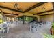 Spacious covered patio with tables and chairs, perfect for outdoor dining and socializing at 7710 E Gainey Ranch E Rd # 115, Scottsdale, AZ 85258