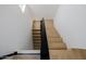 Bright staircase with modern, minimalist design and a sleek black railing offers an open, airy feel at 7710 E Gainey Ranch E Rd # 115, Scottsdale, AZ 85258