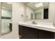 Modern bathroom featuring a sleek vanity with dark wood cabinets and a glass-enclosed shower with mosaic tile accents at 8540 N Central Ave # 6, Phoenix, AZ 85020