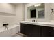 Modern bathroom showcasing a freestanding tub and a vanity with dark cabinets at 8540 N Central Ave # 6, Phoenix, AZ 85020