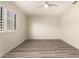 Airy bedroom featuring a ceiling fan and a window with white shutters at 8540 N Central Ave # 6, Phoenix, AZ 85020
