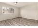Bright bedroom with wood-look flooring, a ceiling fan, and a window with white shutters at 8540 N Central Ave # 6, Phoenix, AZ 85020