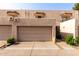 Beige townhome exterior featuring a two-car garage, stucco walls, and classic tile roof at 8540 N Central Ave # 6, Phoenix, AZ 85020