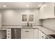 Bright kitchen boasts modern appliances, white cabinets, stone counters, and a stainless steel dishwasher at 8540 N Central Ave # 6, Phoenix, AZ 85020