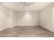 Spacious living room featuring wood floors, neutral walls, a modern ceiling fan and neutral walls at 8540 N Central Ave # 6, Phoenix, AZ 85020