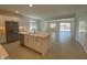 Stylish kitchen island overlooking the living space with stainless steel appliances and plenty of natural light at 10217 W Fairmount Ave, Avondale, AZ 85392