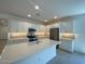 Bright, open kitchen featuring stainless steel appliances, a large island, and white cabinets at 10217 W Fairmount Ave, Avondale, AZ 85392