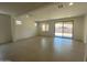 Open-concept living room with tile floors, ample natural light, and sliding glass doors at 10217 W Fairmount Ave, Avondale, AZ 85392