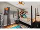 Cozy bedroom with playful decor, a window with blinds, and wood-look flooring at 10951 N 91St Ave # 184, Peoria, AZ 85345