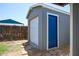 Outdoor shed with both a rolling garage door and a service door for secure storage at 10951 N 91St Ave # 184, Peoria, AZ 85345