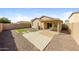 This backyard has pavers, gravel, a covered patio, and a small patch of artificial turf at 11829 W Rosewood Dr, El Mirage, AZ 85335