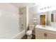 This bathroom has a shower/tub combo, single sink vanity and a large mirror at 11829 W Rosewood Dr, El Mirage, AZ 85335